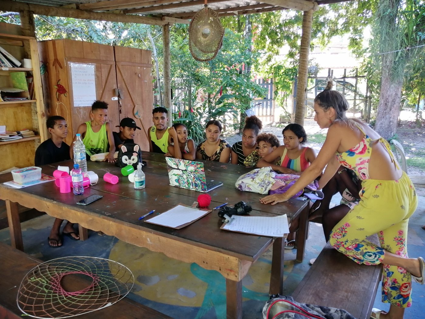 A community learning session with young people gathered around a table
