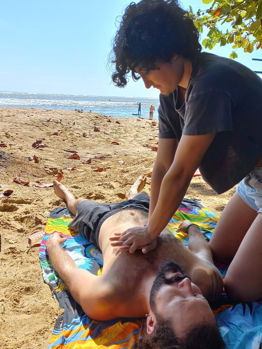 A practical first aid training demonstration on a beach